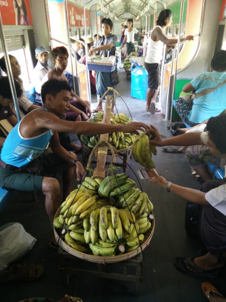 A man selling bananas on the train.