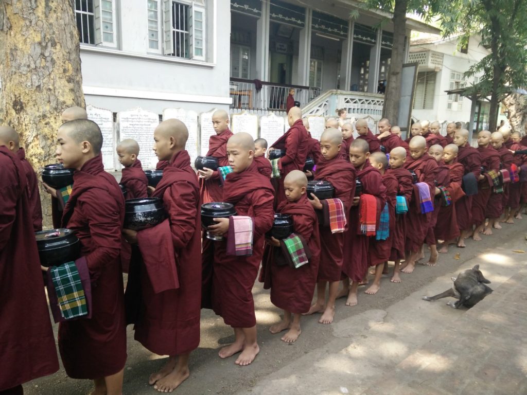 Young monks humbly waiting for their lunch. 