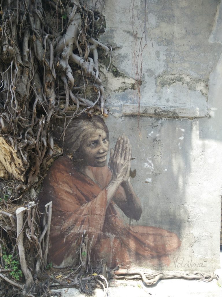 Street art of begging Indian woman.
